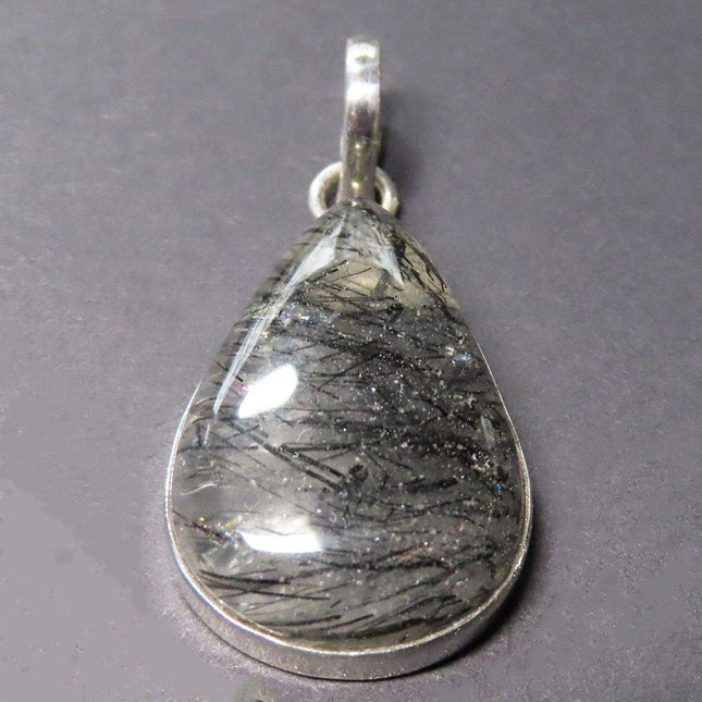 Black Tourmaline in Quartz Sterling Silver Pendant Jewelry on a gray background
