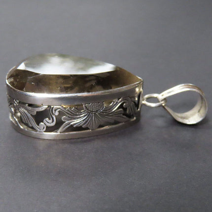 Side View of Smoky Quartz Tear Drop Sterling Silver Pendant Jewelry on a gray background