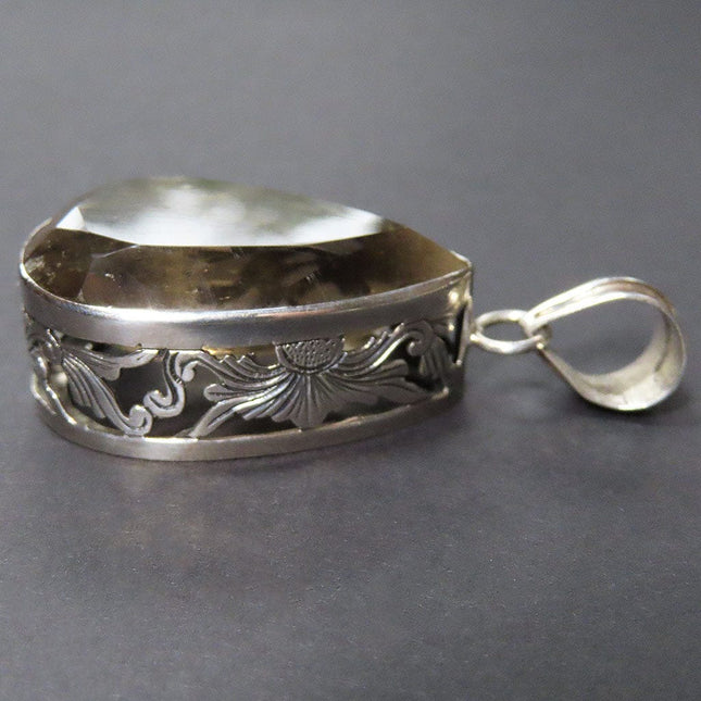 Side View of Smoky Quartz Tear Drop Sterling Silver Pendant Jewelry on a gray background