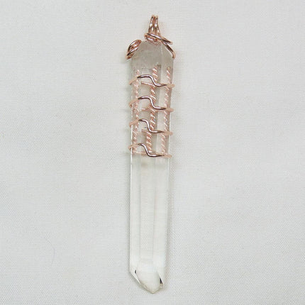 Quartz Crystal Point from Arkansas Wire Wrapped Pendant Jewelry on a light gray background