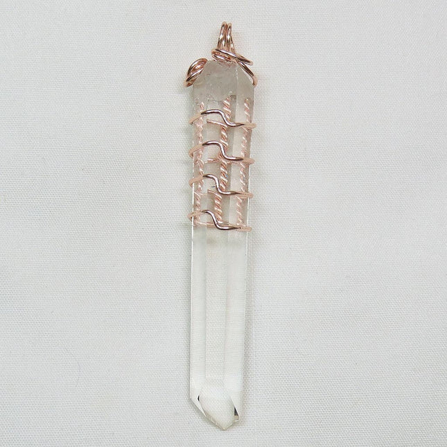 Quartz Crystal Point from Arkansas Wire Wrapped Pendant Jewelry on a light gray background