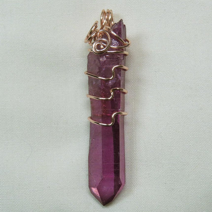 Purple Mist Aura Quartz Crystal Wire Wrapped Pendant Jewelry on a light gray background