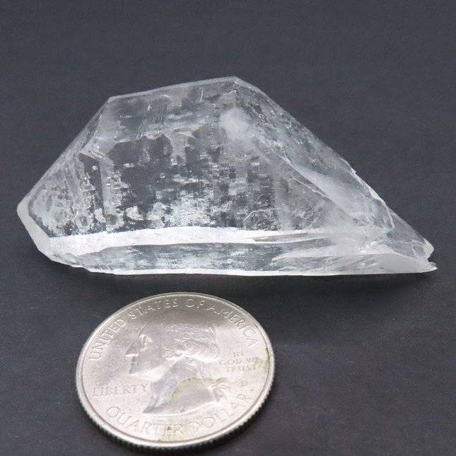 Arkansas Quartz Crystal Double Terminated/ET Point with Time-Link next to a U.S. quarter coin for scale on a dark background