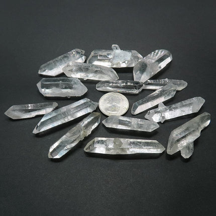 12 Arkansas Quartz Crystal Double Terminated Points & 3 DT/ET Points with a quarter for scall on a dark background