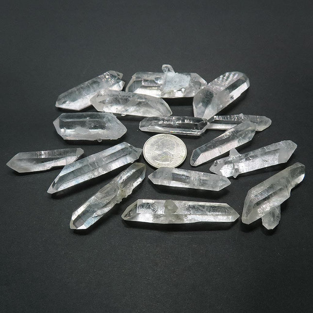12 Arkansas Quartz Crystal Double Terminated Points & 3 DT/ET Points with a quarter for scall on a dark background