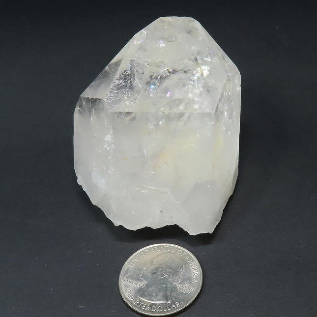 Arkansas Quartz Crystal Etched Point with Rainbow & Self-Healed Base next to a U.S. quarter for scale on a dark background