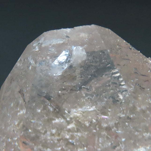 Close-up of an Arkansas Quartz Crystal Tabby Point with Manifestation with a dark background