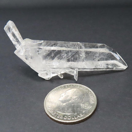 Arkansas Quartz Crystal Double Terminated Point next to a US quarter on a dark surface