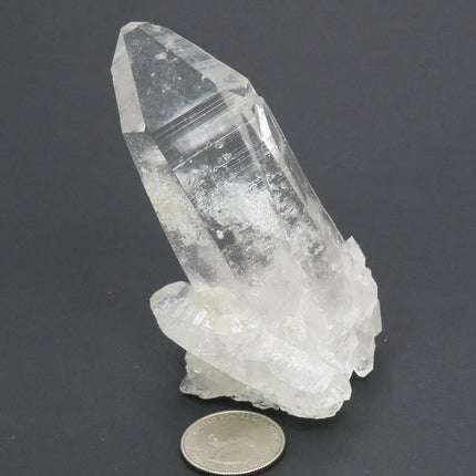 Arkansas Quartz Crystal Burr Cluster with Rainbow with a quarter for scale and a dark gray background