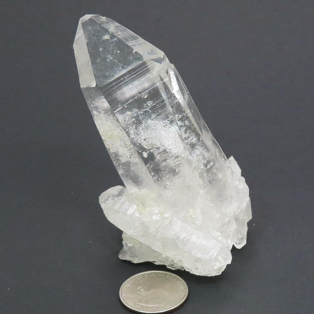 Arkansas Quartz Crystal Burr Cluster with Rainbow with a quarter for scale and a dark gray background