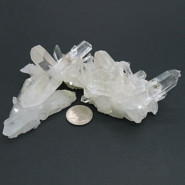 Arkansas Quartz Crystal Cluster with 4" Long DT & Time-Link Activations and a quarter for scale on a dark background