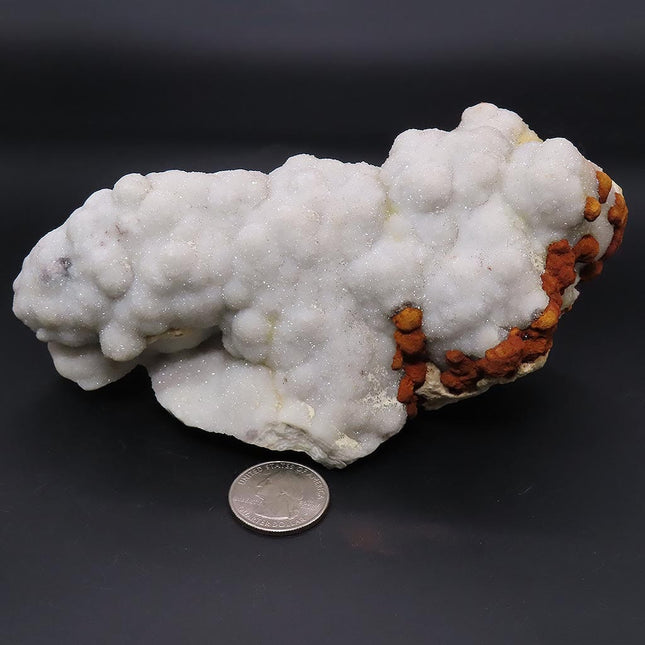 Sparkling White Botryoidal Drusy Quartz with Barite from Missouri with a quarter for scale on a black background