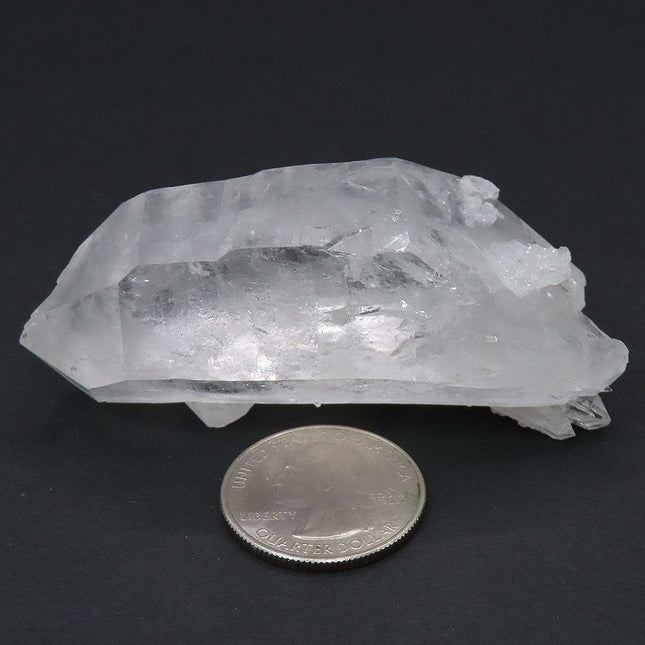 Arkansas Quartz Crystal Double Terminated/ET Point with Tabby next to a quarter for scale on a dark background